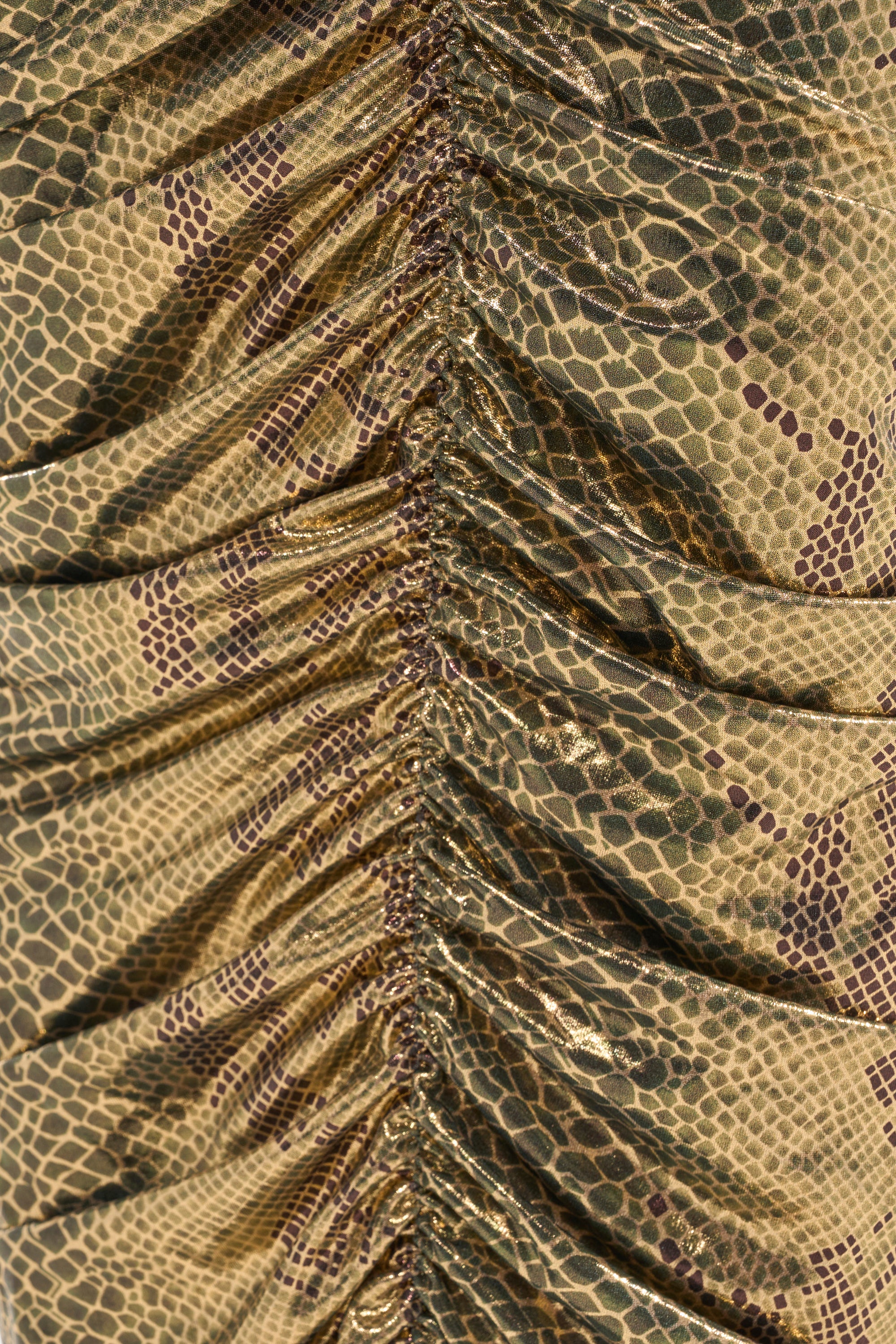 Close-up of the SNEAKY LITTLE SNAKE MAXI SKIRT featuring metallic tan and brown snakeskin, ruched fabric, and gathered vertical folds for a curve-skimming silhouette. 6