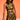 A woman with long, wavy dark hair stands against an orange background, confidently wearing the SEXY CAN I MOCKNECK BLOUSE WITH CUTOUT and a matching skirt, holding a gold purse.