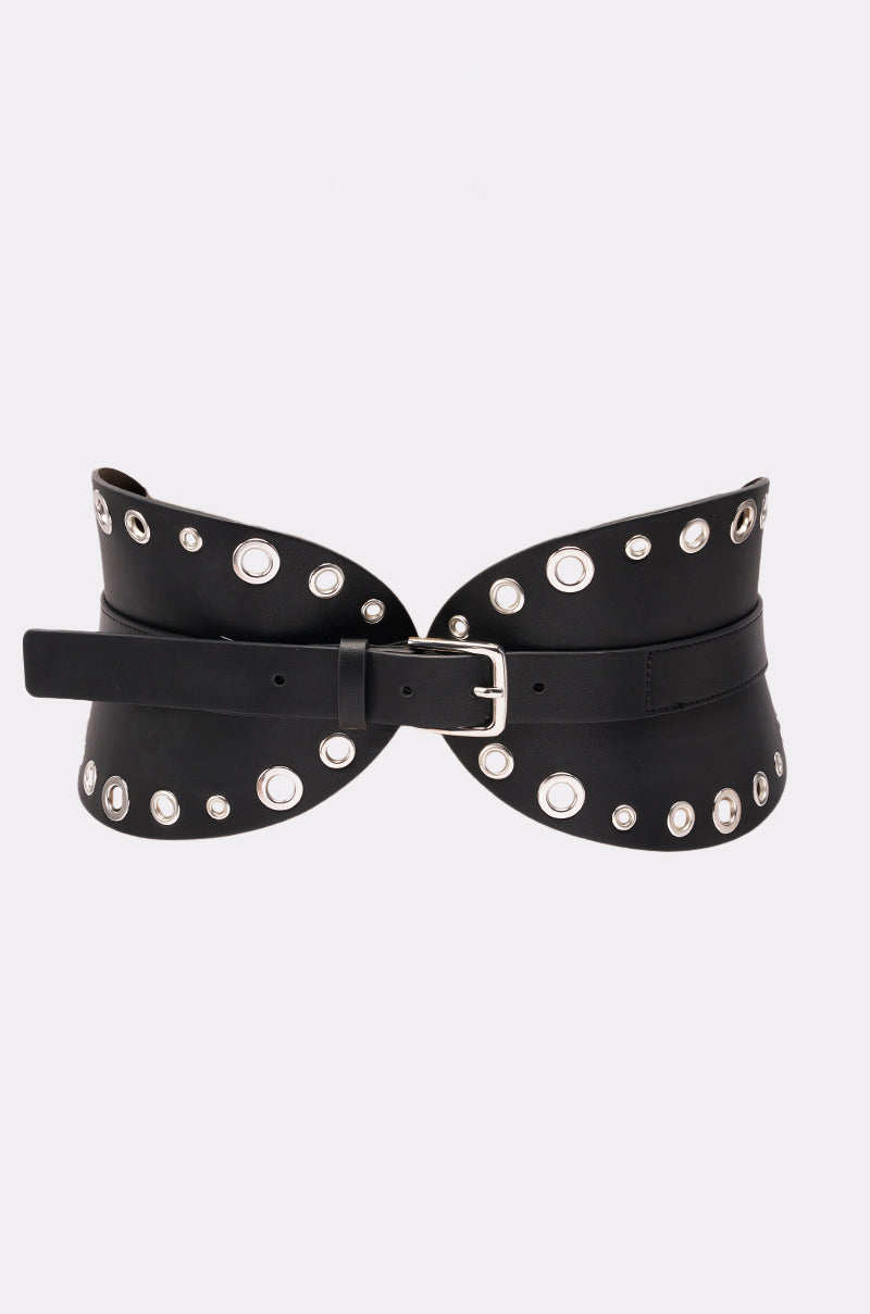 The CINCH IT BELT is a wide faux leather belt with silver grommet details and a silver buckle, designed in a curved corset style, shown against a plain white background. 2