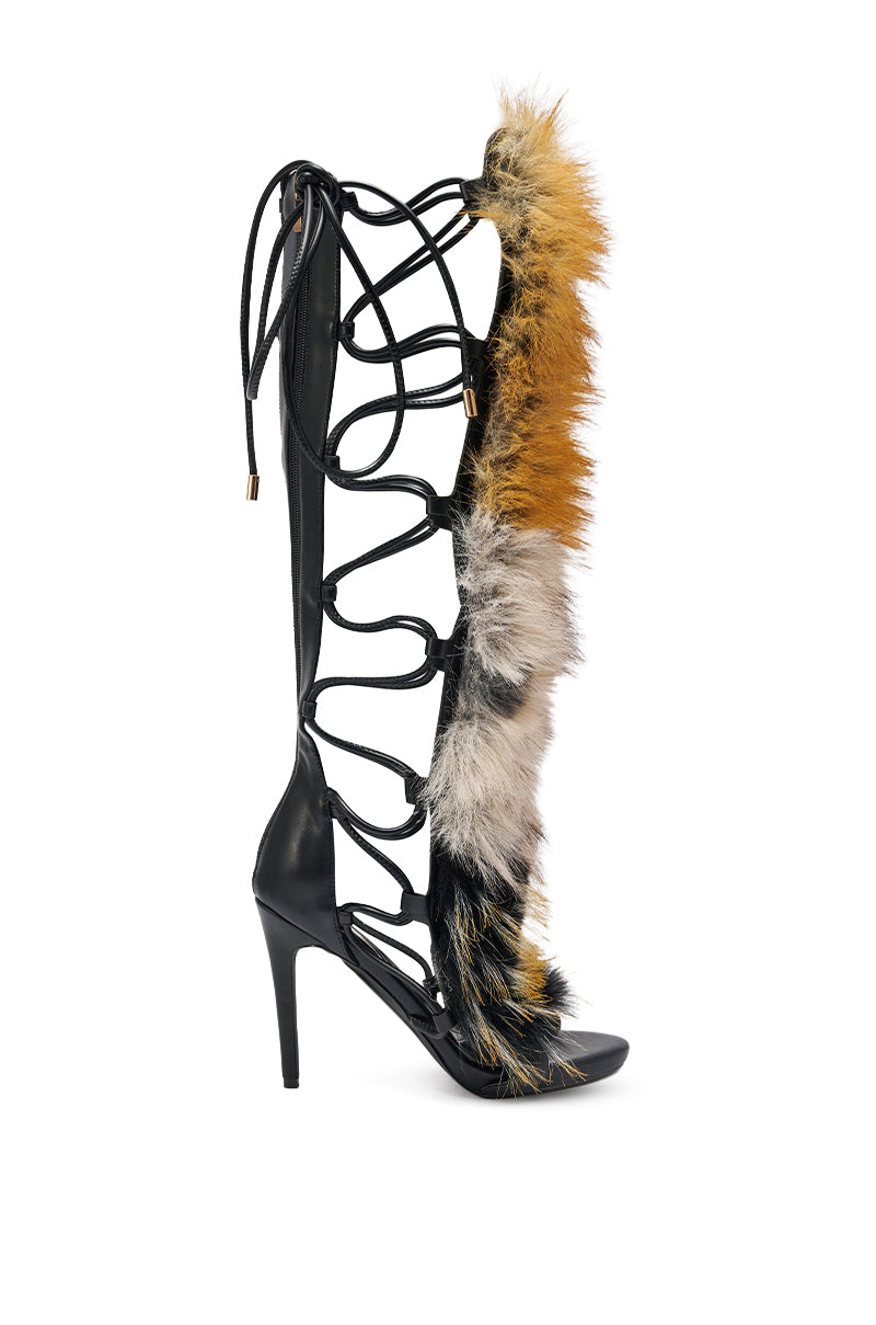 The AZALEA WANG STAMOS BLACK MULTI FUR GLADIATOR STILETTO SANDAL features black leather straps, open sides, a lace-up front, and bold multicolored faux fur trim along the front. 8