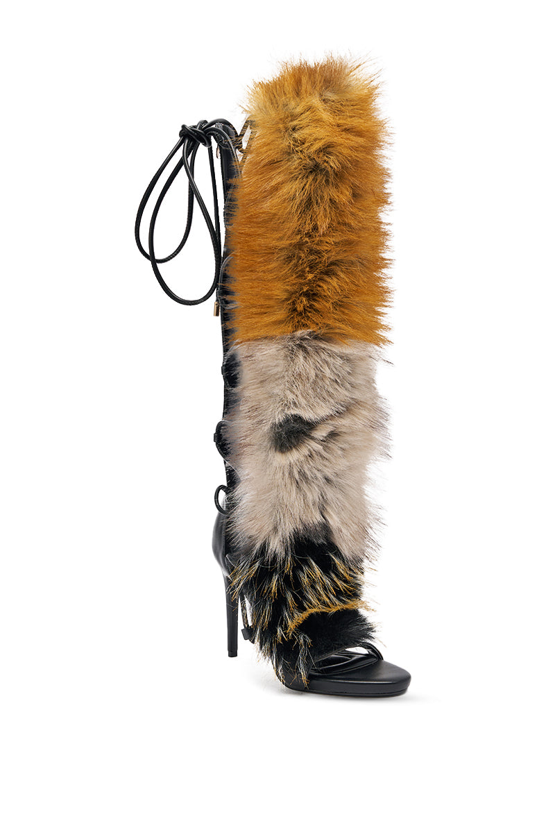 The AZALEA WANG STAMOS BLACK MULTI FUR GLADIATOR STILETTO SANDAL features a knee-high gladiator design, black leather sole, open toe, multi-colored faux fur upper in orange, beige, black, and white, plus lace-up straps at the back. 9