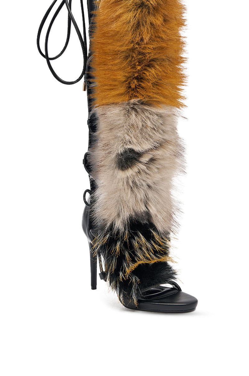 The AZALEA WANG STAMOS BLACK MULTI FUR GLADIATOR STILETO SANDAL is a high-heeled, open-toe black leather sandal with vibrant orange, gray, black, and white faux fur panels and lace-up, wrap-around straps for a bold look. 11