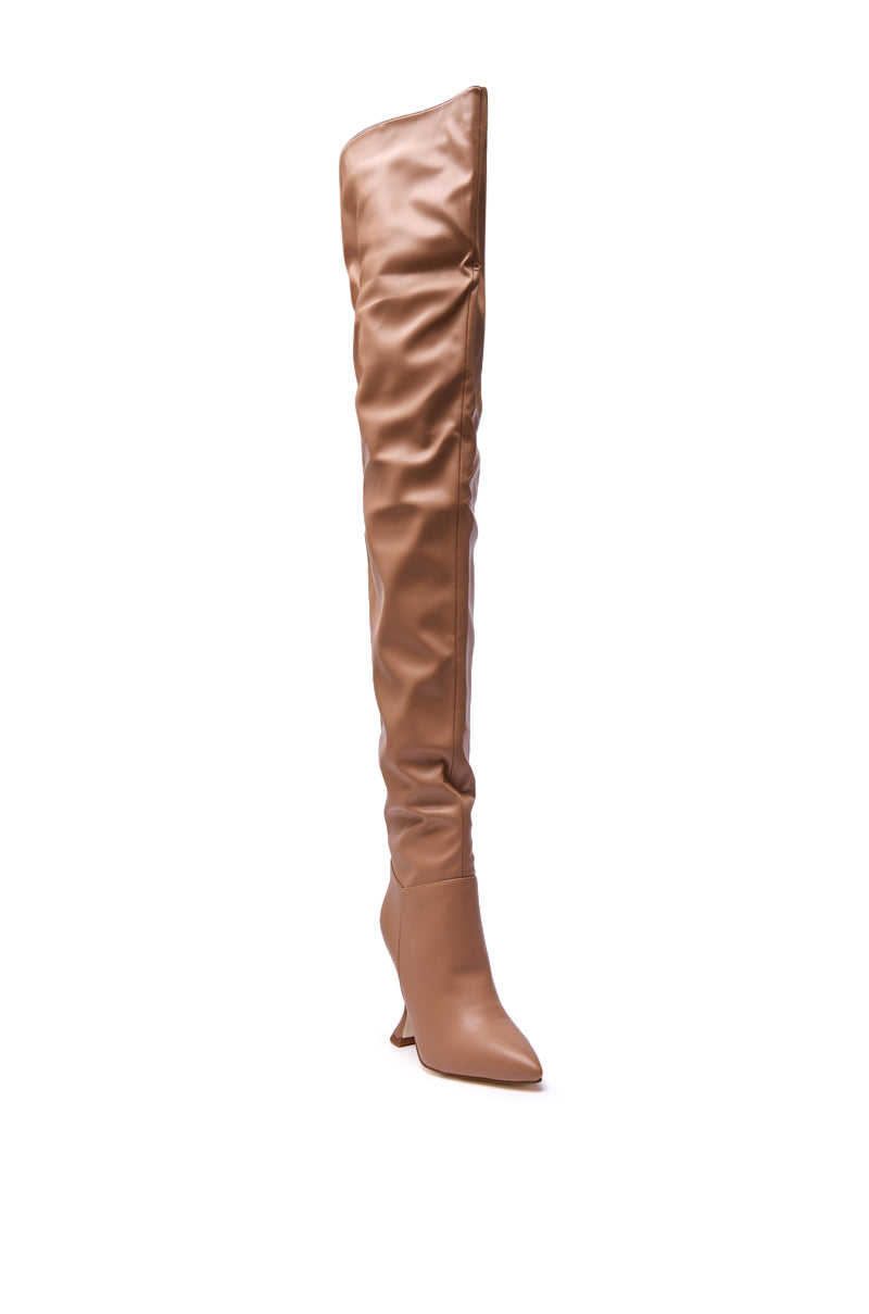 The AZALEA WANG STEPHAN BEIGE PU FLARED HEEL RUCHED BOOT is a single tan, faux leather, over-the-knee boot featuring a flared high heel, pointed toe, and a slouchy ruched design.