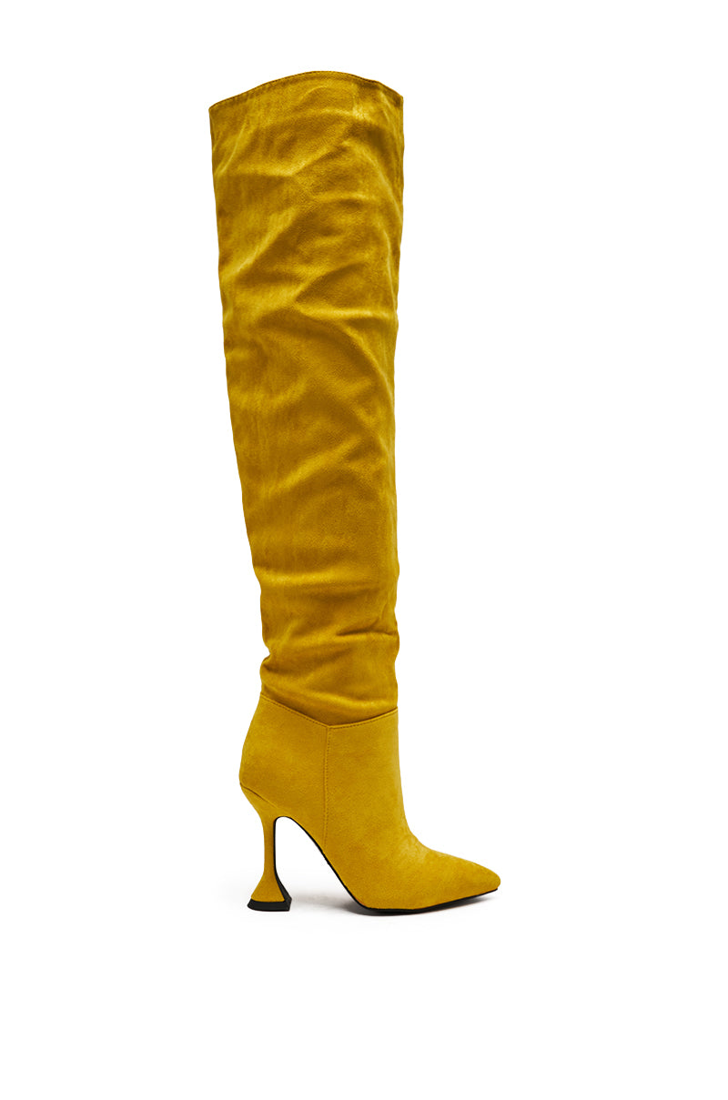 The AZALEA WANG STEPHAN YELLOW SUEDE CHUNKY BOOT, a single knee-high boot with a pointed toe and chunky heel, is displayed against a white background.