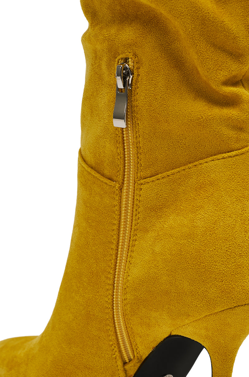 Close-up of the AZALEA WANG STEPHAN Yellow Suede Chunky Boot showcasing its silver side zipper, high heel, soft suede texture, and detailed stitching.