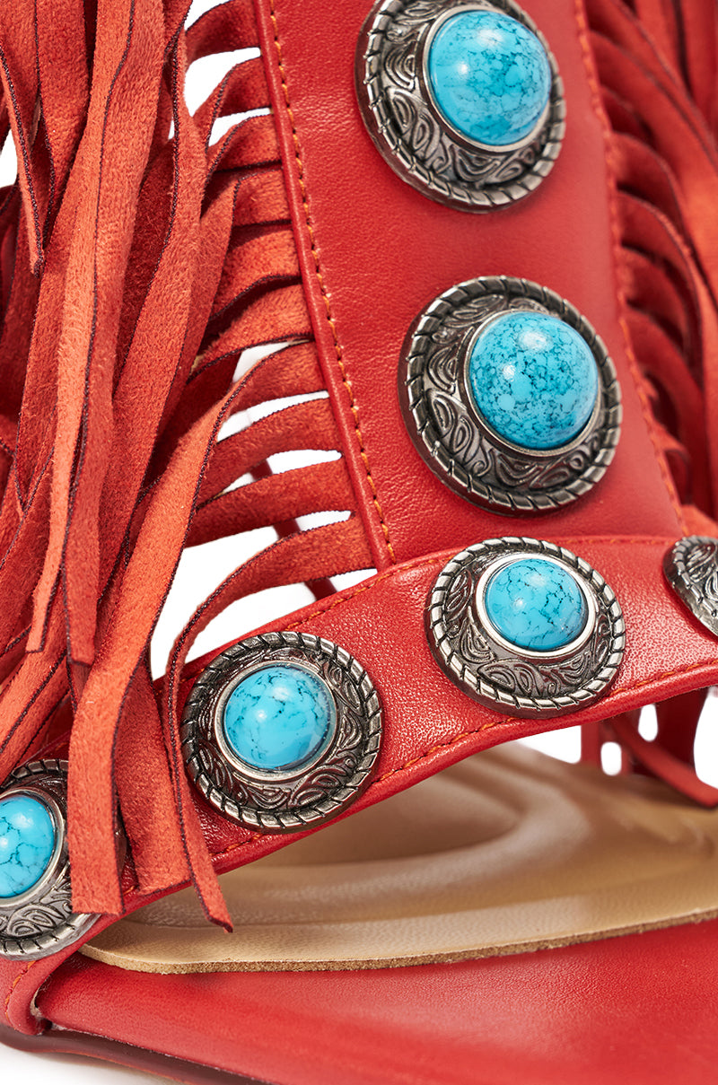 The AZALEA WANG SUMAC RED FRINGE WESTERN STILETTO SANDAL features red leather, silver and turquoise conchos, long fringe accents, intricate western designs, and a cushioned tan footbed for comfort and standout style. 6