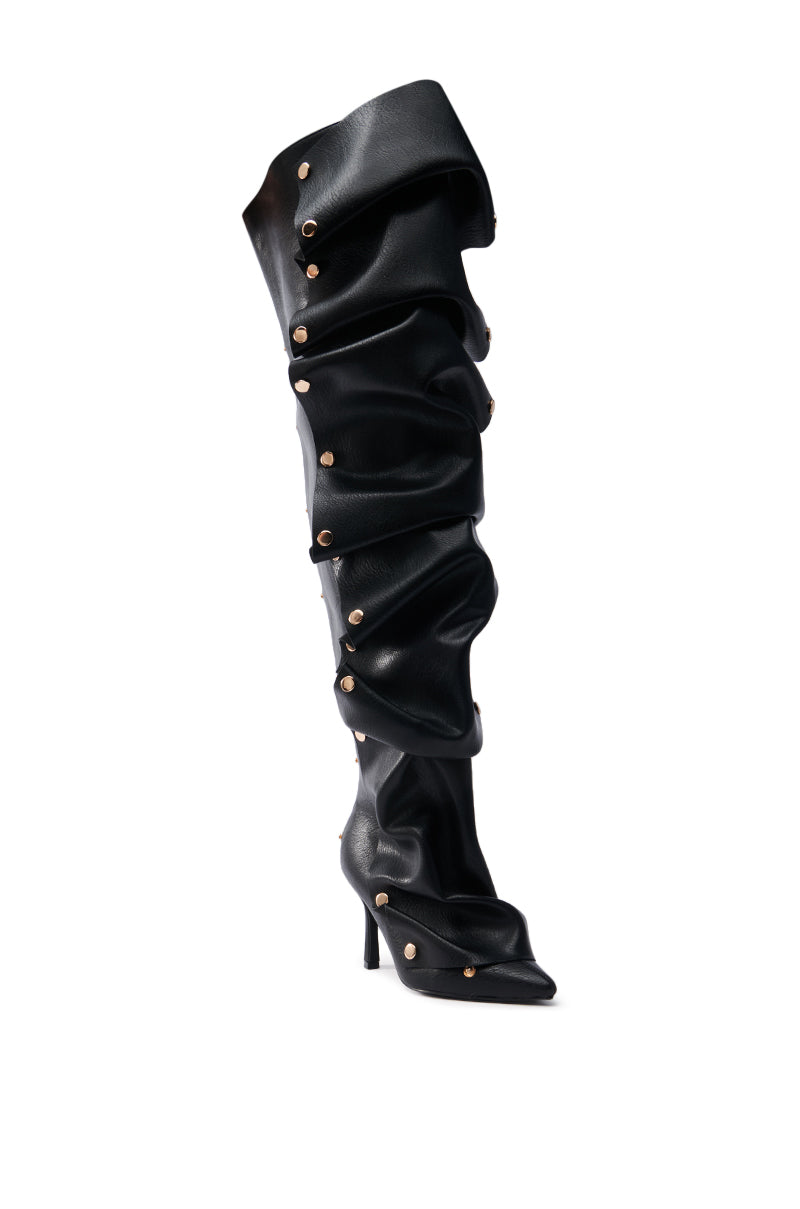 The AZALEA WANG SWELCIE BLACK PU GOLD HARDWARE STILETTO BOOT is a thigh-high stiletto boot with a slouchy, ruched faux leather design. It features gold studs along the seams, extends over the knee, and comes with a pointed toe and slim heel.
