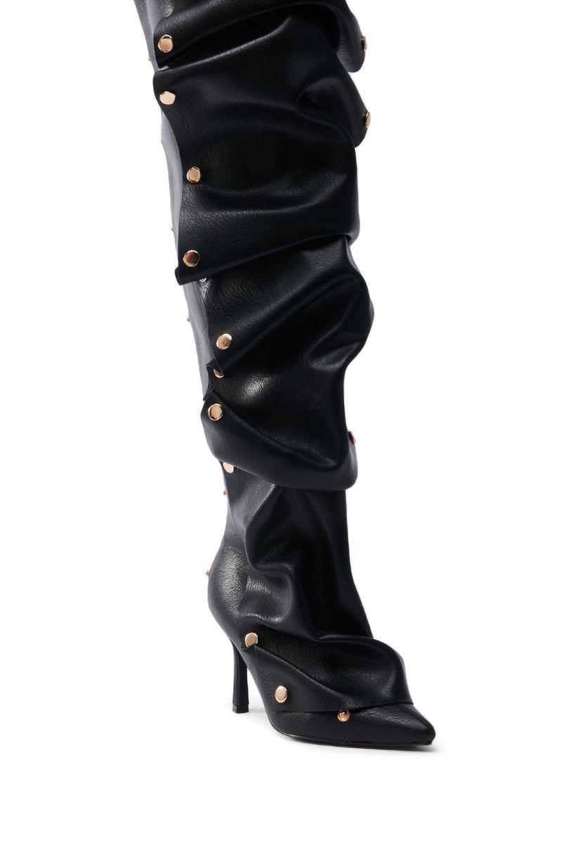 The AZALEA WANG SWELCIE Black PU Stiletto Boot features a slouchy design with decorative gold hardware. It has a pointed toe and a slim stiletto heel.