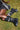 A person lies on grass wearing a black skirt with white stripes and AZALEA WANG SYBEL BUTTON FLAT BOOTIE mid-calf platform boots; only their legs and part of one arm are visible.