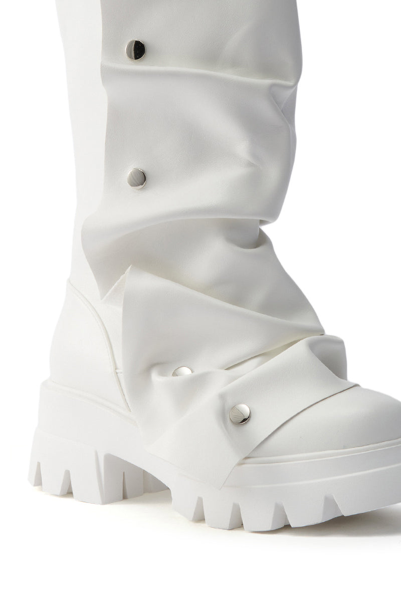 Close-up of the AZALEA WANG SYBEL WHITE SNAP DETAIL BOOTIE, showcasing its chunky heel, platform lug sole, and silver studs on a slouched shaft for a bold, edgy look. Thick ridged sole adds modern appeal.