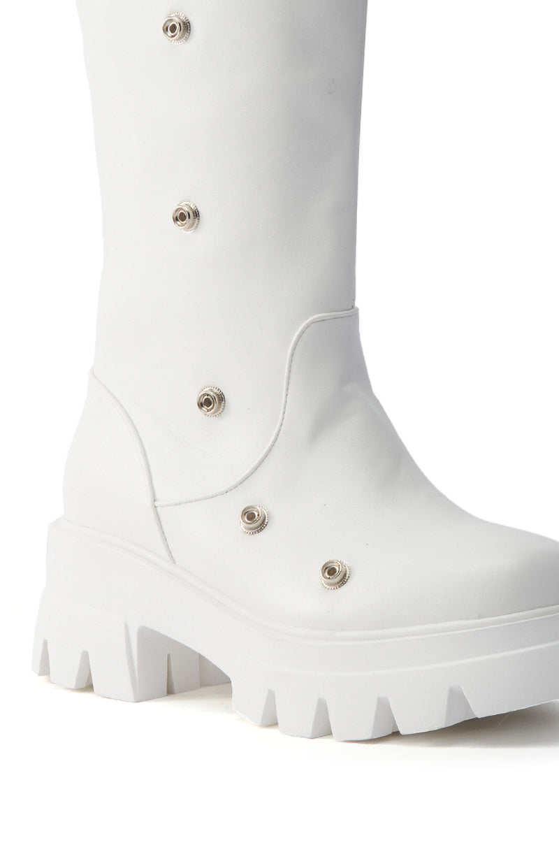 Close-up of the AZALEA WANG SYBEL WHITE SNAP DETAIL BOOTIE, a knee-high boot with a chunky heel, platform lug sole, metallic stud accents, smooth texture, and a modern, edgy design.