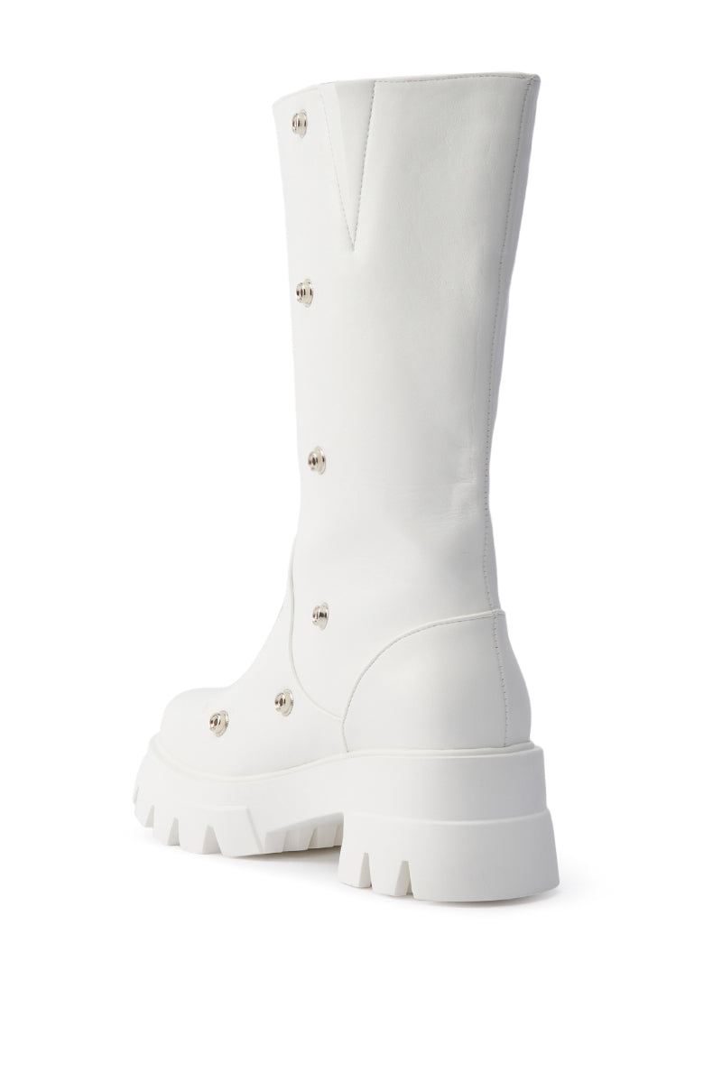 The AZALEA WANG SYBEL WHITE SNAP DETAIL BOOTIE is a tall, white leather boot with a chunky platform lug sole, smooth finish, small round metal studs along the side, and a slightly pointed top edge.