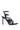 The AZALEA WANG SYDONDIA BLACK WATCH SHOE STILETTO SANDAL is a high-heeled faux patent leather sandal with adjustable ankle straps, silver buckles, pointed spikes, and metallic watch faces for an edgy industrial look.