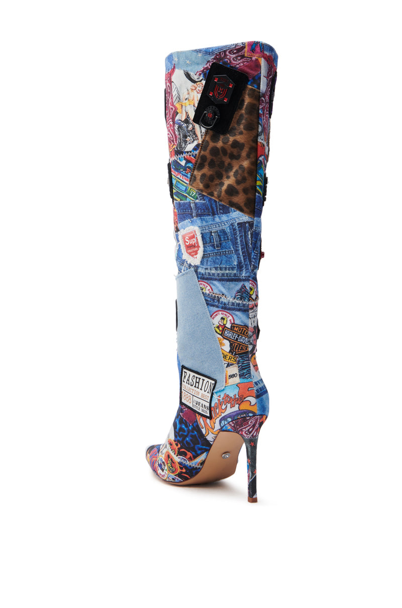 The AZALEA WANG SYTILA MULTI ABSTRACT BOOT features a vibrant knee-high design, stiletto heel, and a bold collage of denim patches, leopard print, and logos. Adorned with "Fashion" and "Super Girl," these boots make a fierce statement wherever you go.