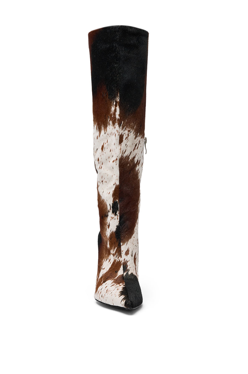 Front view of the AZALEA WANG SYREALI COW STILETTO BOOT, a knee-high boot with a pointed toe, brown, black, and white cowhide pattern, a slight sheen, and a visible side zipper. 5