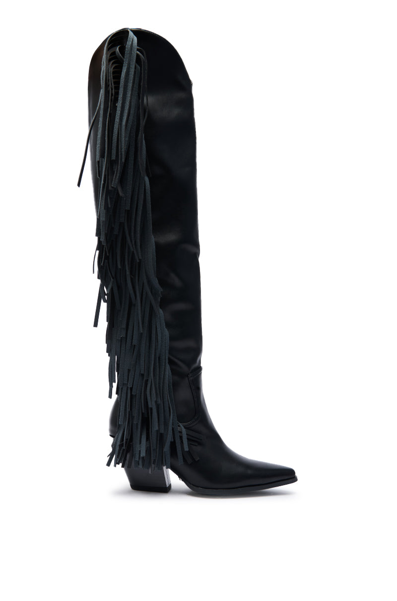 The AZALEA WANG SZYMON Black Western Boot features faux leather, a tall silhouette, pointed toe, block heel, and long black fringe cascading down the side.