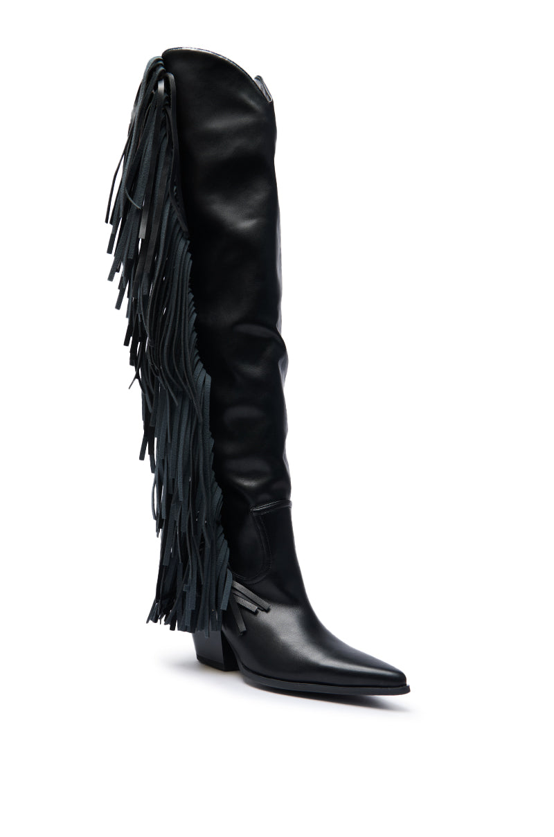 The AZALEA WANG SZYMON Black Western Boot features a faux leather knee-high design, a pointed toe, low block heel, and eye-catching fringe detailing on the outer side for a chic western flair.