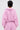 Seen from behind, a person with short dark hair wears the BUBBLEGUM BUBBLE HEM BOMBER and matching pants with distressed fringe, creating a soft cropped silhouette against a plain light background.