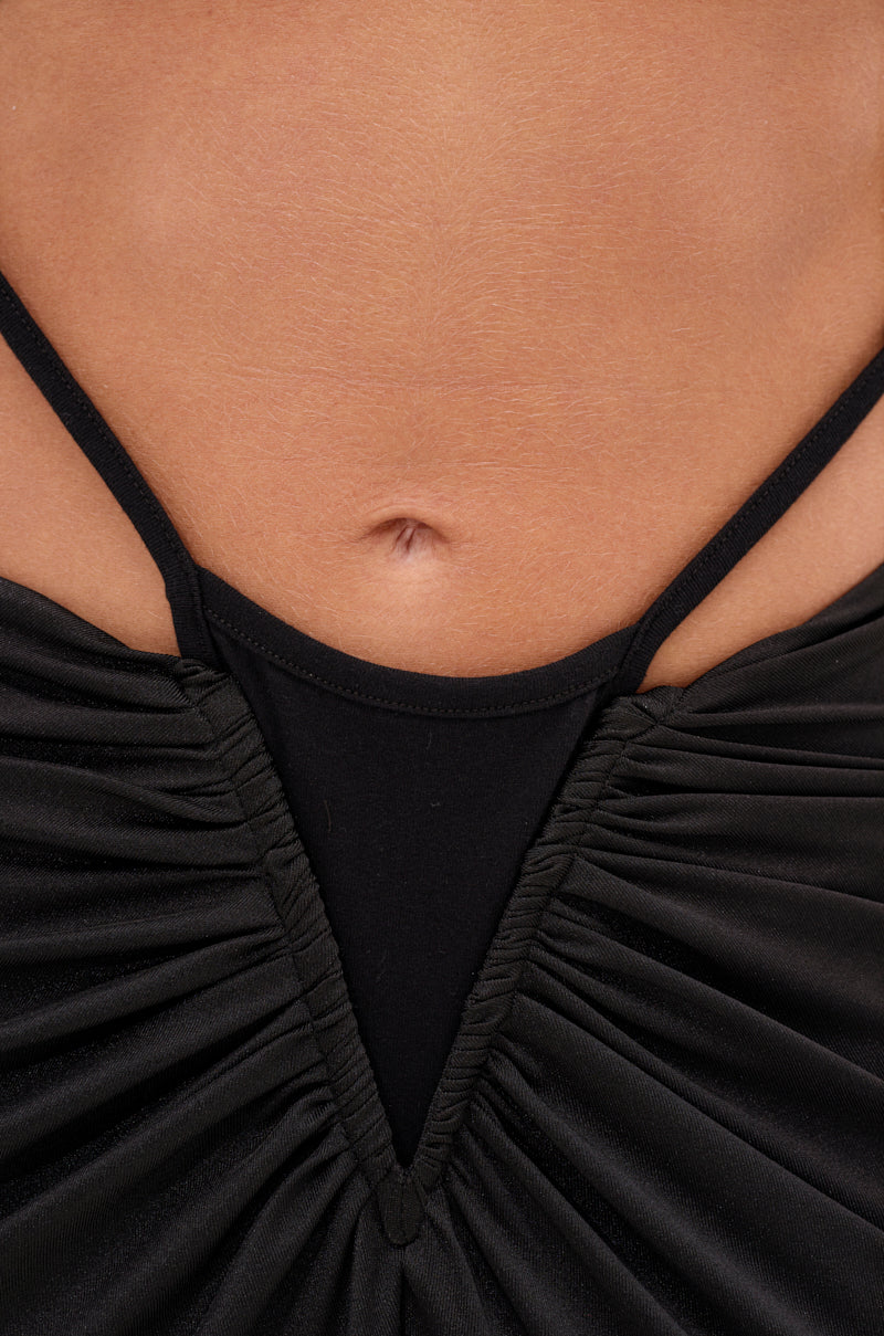 Close-up of a person's midriff wearing the TOO SEXY FOR THIS BODYSUIT—a black, ruched piece with thin straps that reveals their belly button and upper abdomen. 9