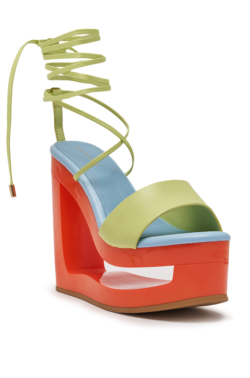 The AZALEA WANG TAFFY MULTI NOVELTY WEDGE MULE SANDAL features a colorblock design with a bright red cutout wedge, light blue footbed, light green front strap, and matching green lace-up ankle ties. 4