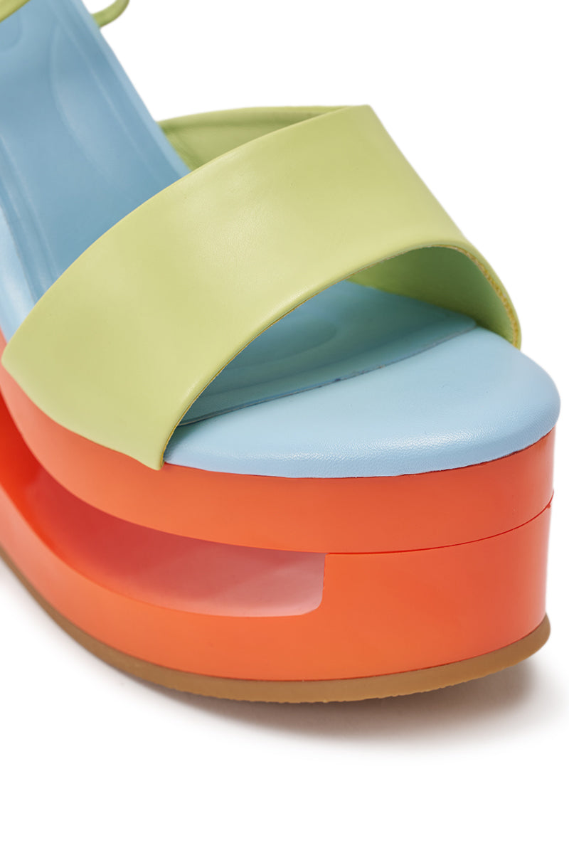 Close-up of the AZALEA WANG TAFFY MULTI NOVELTY WEDGE MULE SANDAL with a light green strap, blue footbed, vivid orange platform heel featuring a cutout detail, and tan sole. 6