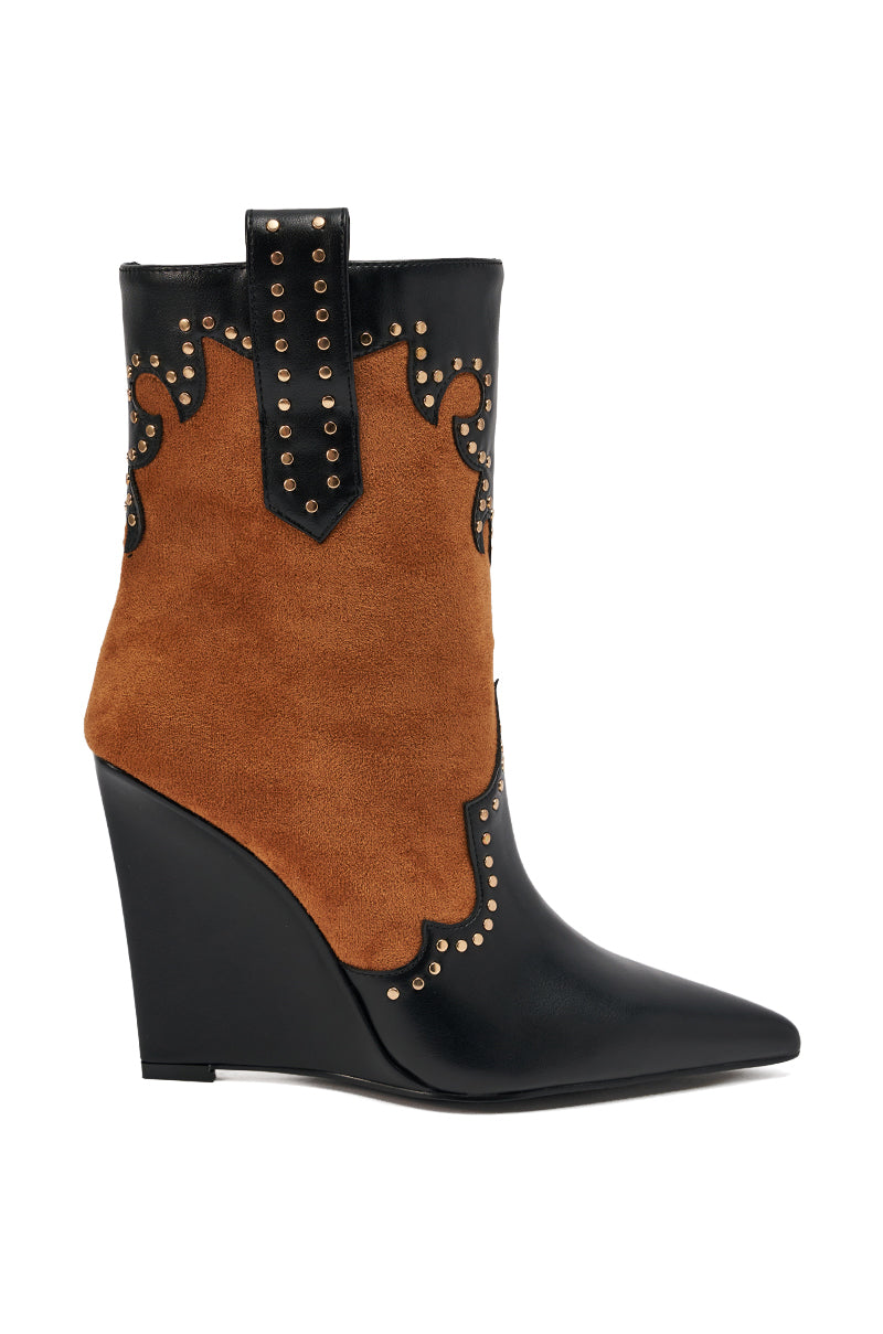 The AZALEA WANG TALLULAH COGNAC WEDGE WESTERN BOOTIE features a black pointed toe and heel, cognac suede midsection, black leather trim, gold studs, and a decorative pull tab for a chic cowboy-inspired look.