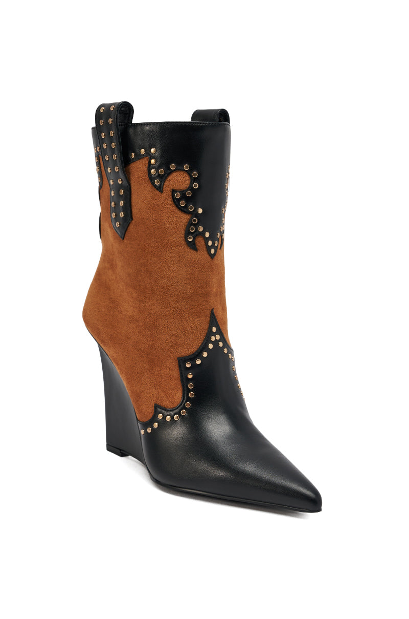 The AZALEA WANG TALLULAH COGNAC WEDGE WESTERN BOOTIE features a pointed toe, black leather, cognac suede panels, gold decorative studs, and a wedge heel for a stylish Western look.
