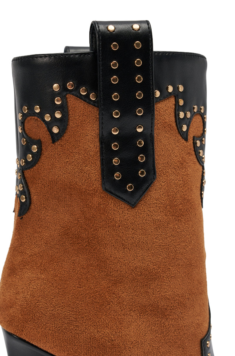Close-up of the AZALEA WANG TALLULAH COGNAC WEDGE WESTERN BOOTIE featuring cognac suede, black leather, decorative gold studs, scalloped detailing, and a pointed toe silhouette.