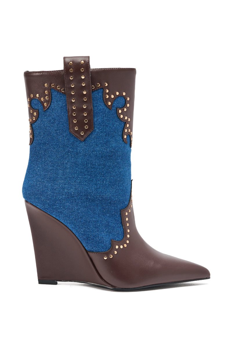 The AZALEA WANG TALLULAH DENIM WEDGE WESTERN BOOTIE is a mid-calf style with a pointed toe, brown faux leather and blue denim panels, gold studs, and decorative stitching, shown in side profile.