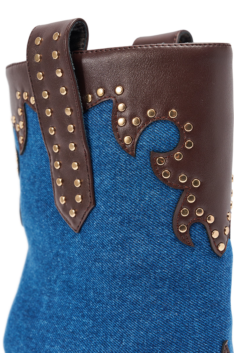 Close-up of the AZALEA WANG TALLULAH DENIM WEDGE WESTERN BOOTIE featuring gold studs, decorative stitching on the faux leather upper, and a side pull strap.