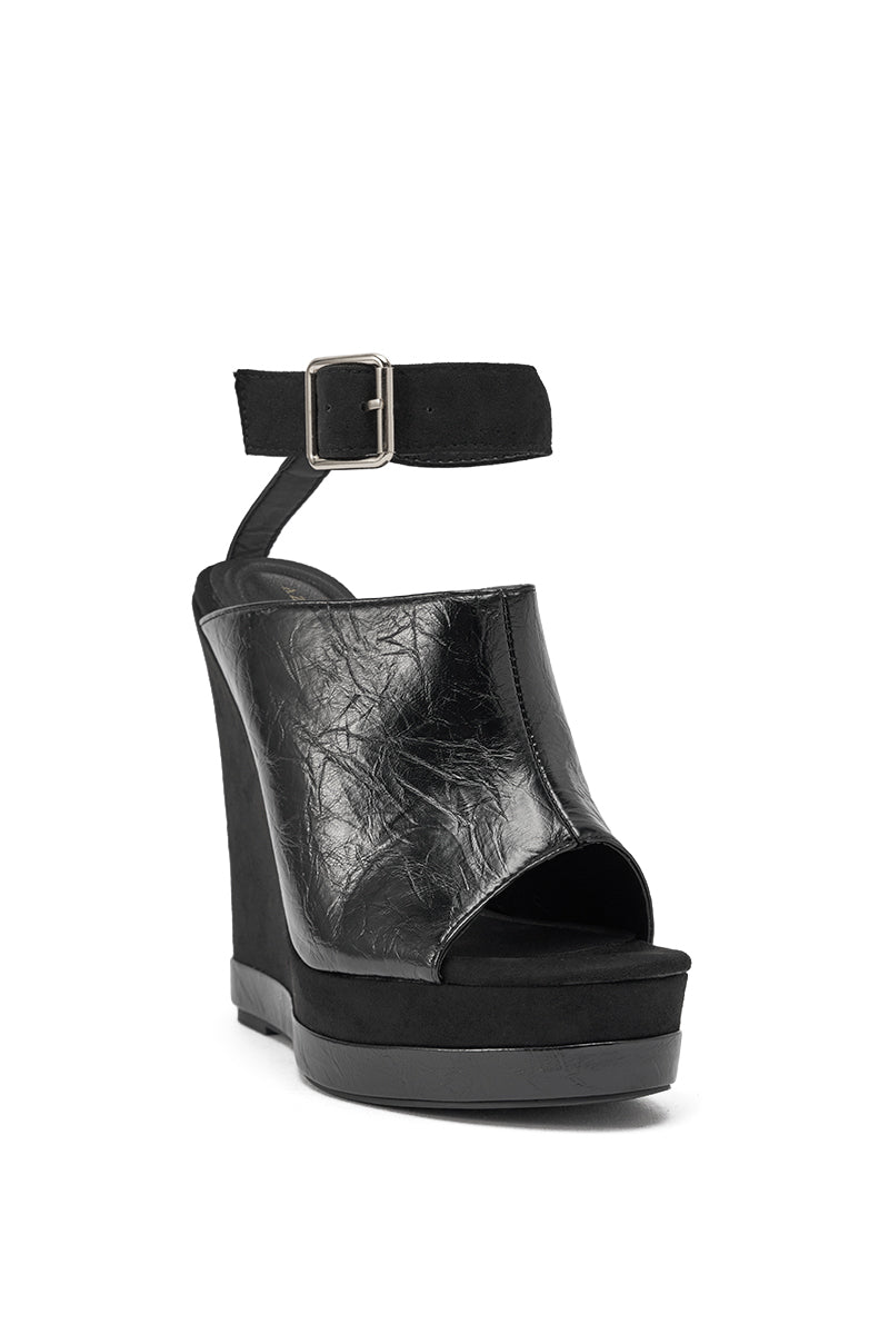 The AZALEA WANG TANA BLACK MIXED MATERIAL WEDGE features a textured faux leather upper, open toe, thick platform sole, and an ankle strap with a square metal buckle. 4