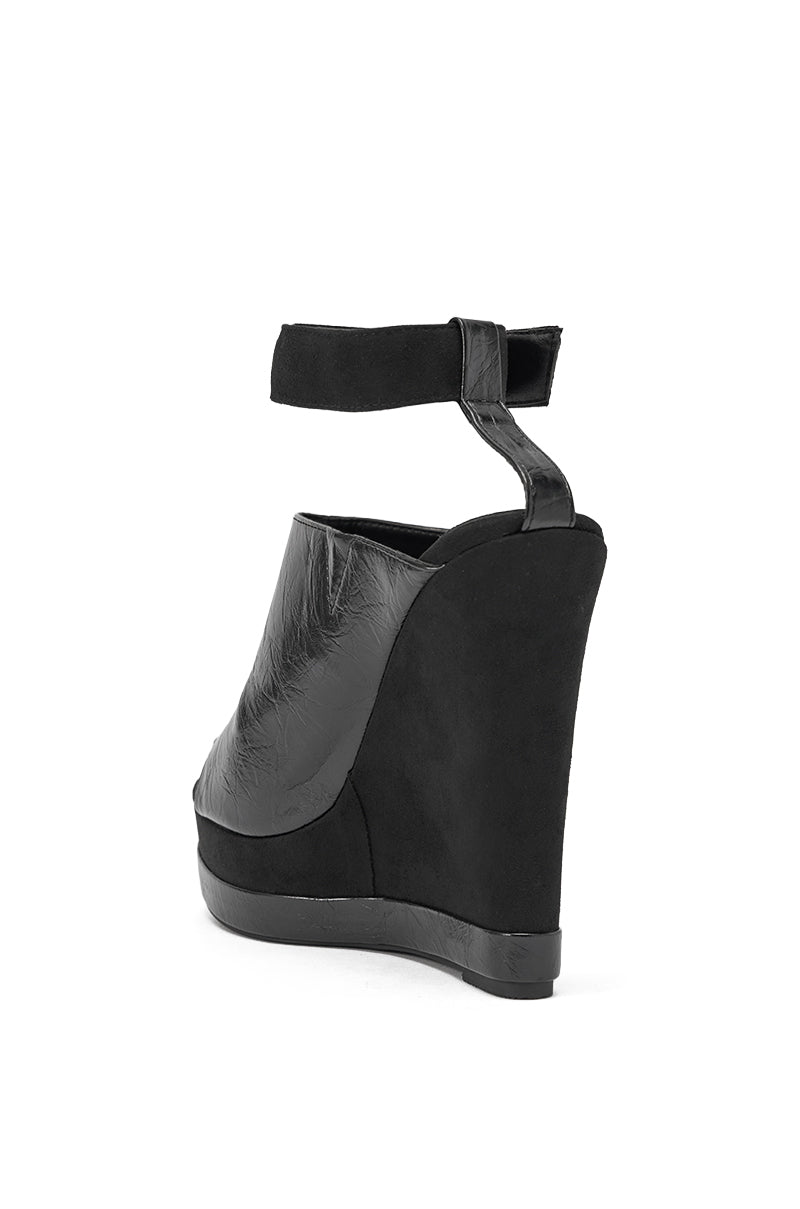The AZALEA WANG TANA Black Mixed Material Wedge features a closed toe, ankle strap, and textured faux leather and suede upper, shown from the back on a white background. 5