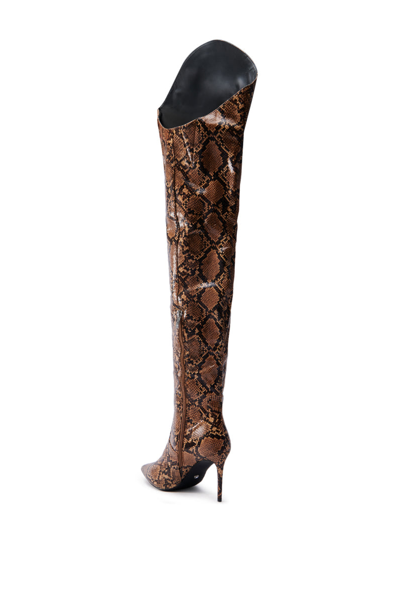 The AZALEA WANG TARRANT Snake Western Topline Boot, a single knee-high boot with a brown snakeskin pattern and high stiletto heel made from faux leather, is displayed against a plain white background.