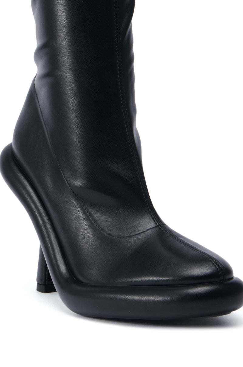 Close-up of the AZALEA WANG TARROW Stiletto PU Bootie in Black with a smooth faux leather upper, showcasing a sleek and modern design. This boot presents a rounded toe and a distinctive, slightly curved heel.