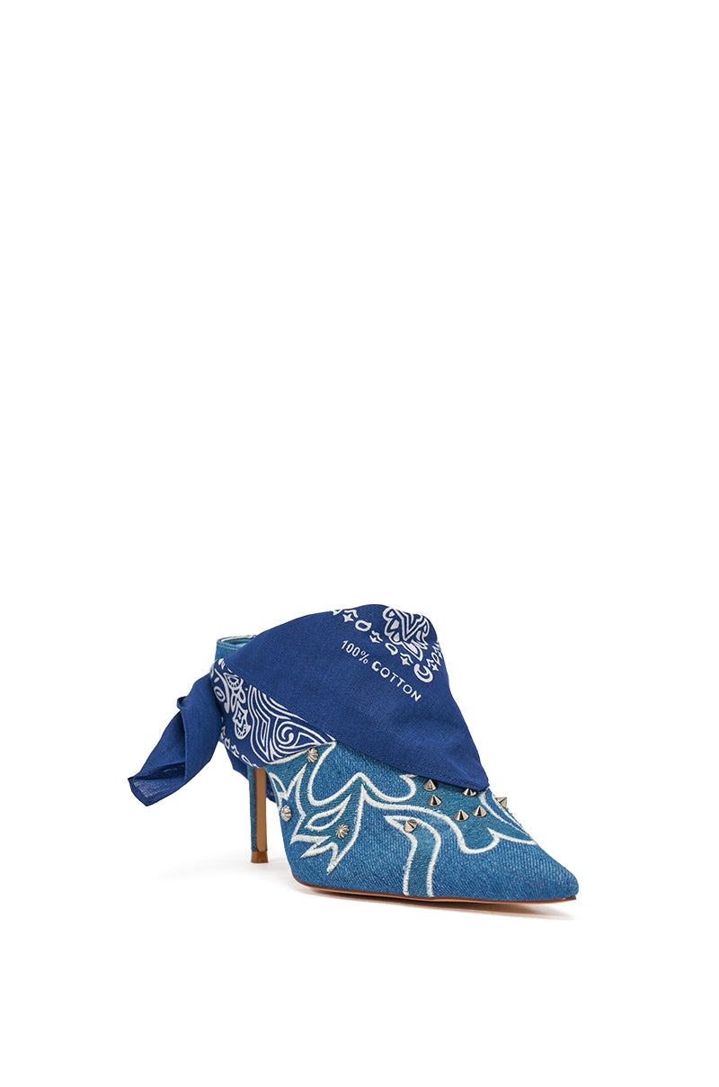 The AZALEA WANG TAVINE DENIM MULE PUMP features a pointed toe, stiletto heel, blue denim with white floral patterns, and a blue bandana ankle tie with white paisley designs and "100% cotton" text. 6