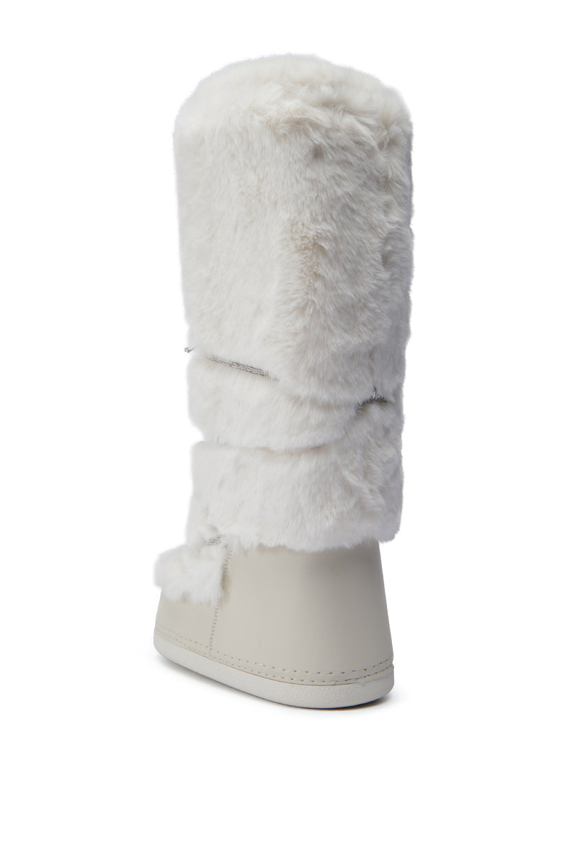 The AZALEA WANG TAYTON beige fuzzy flat knee-high boot is displayed against a plain white background, featuring a single boot with a tall, beige faux fur upper and smooth lower section. The view from the back highlights its soft, textured appearance.