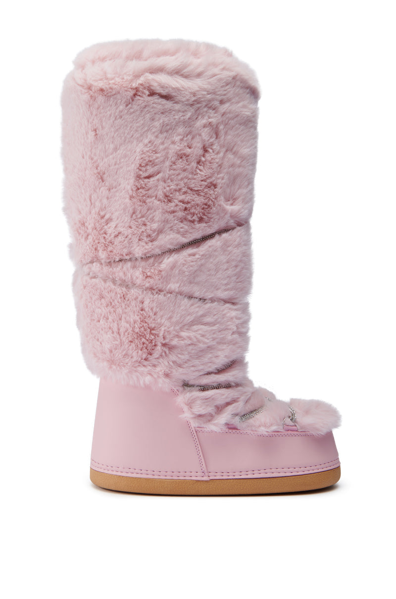 The AZALEA WANG TAYTON PINK FUZZY FLAT KNEE HIGH BOOT features a faux fur upper with lace-up details on the front. Designed for warmth and style, these pink knee-high boots showcase a fluffy texture and smooth base.
