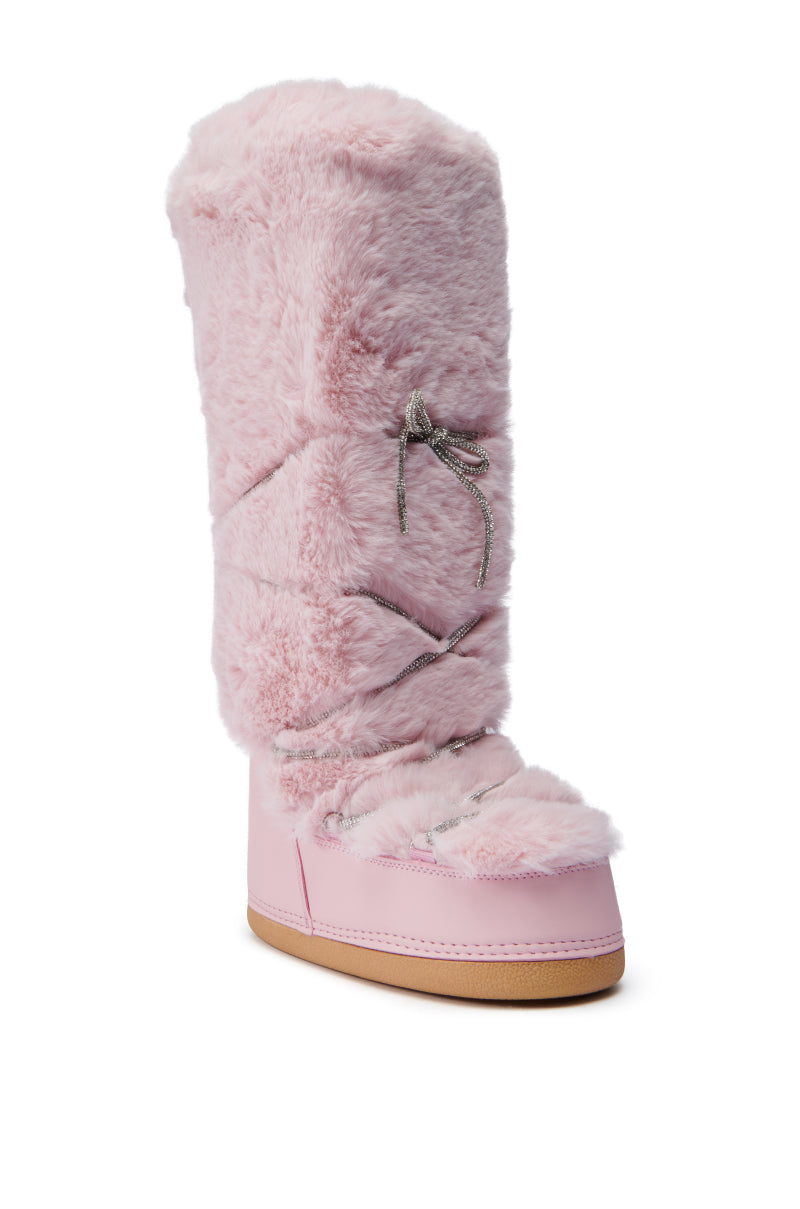 The AZALEA WANG TAYTON PINK FUZZY FLAT KNEE HIGH BOOT is designed with a faux fur upper in a lovely shade of pink and features gray crisscross laces up the front. It has a light brown sole and a rounded toe, providing both warmth and style.