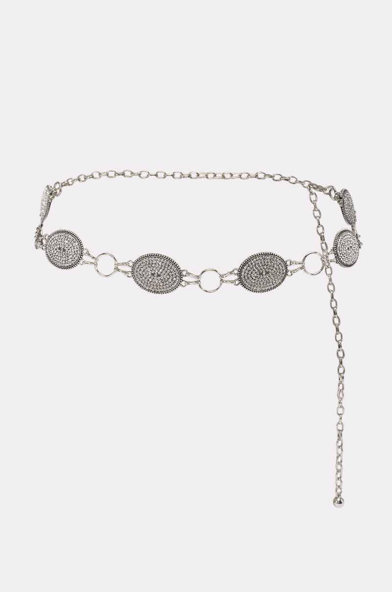 GNO BLING CHAIN BELT with oval, textured medallion accents and interlocking rings, featuring an adjustable dangling chain with a small bead at the end, displayed against a plain white background.