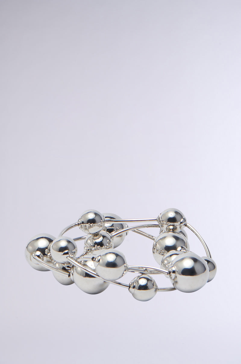 The JUST BEAD IT BRACELET SET showcases mirrored metallic beads with interconnected silver spheres of various sizes, forming a striking and intricate design against a light gray backdrop. 0