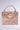 The BROCADE BABE TRUNK BAG is a luxurious rectangular bag with ornate pink and gold baroque brocade, metallic hardware, jewels, intricate pattern, top handle, gold clasp lock at the front, and a neutral light gray background.