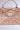 The BROCADE BABE TRUNK BAG is a luxurious trunk bag featuring intricate gold embroidery and gemstones, metallic hardware with a central decorative lock, a shimmering pink and gold texture, and a sturdy top handle.