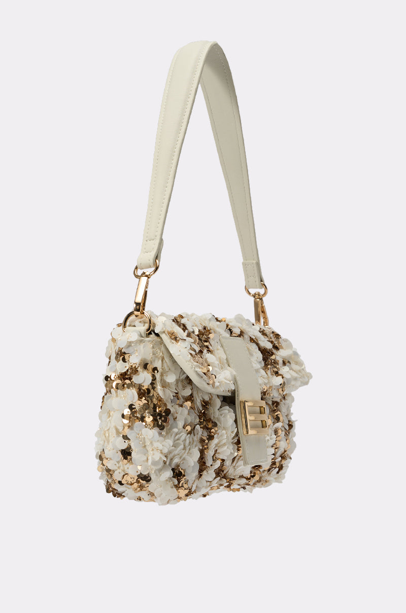 The BOUJEE BABE SEQUIN PURSE is a gold and white bag with a textured surface, featuring white floral appliqués and gold sequins, a gold clasp, and a white leather shoulder strap—perfect for parties. 2