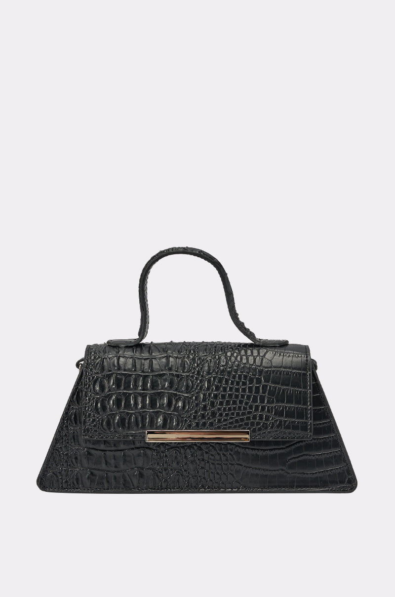 The VILLAIN ERA PURSE is a black, croc-embossed faux leather handbag with a trapezoid shape, short handle, and gold horizontal bar on the front flap, displayed against a plain light background. 0