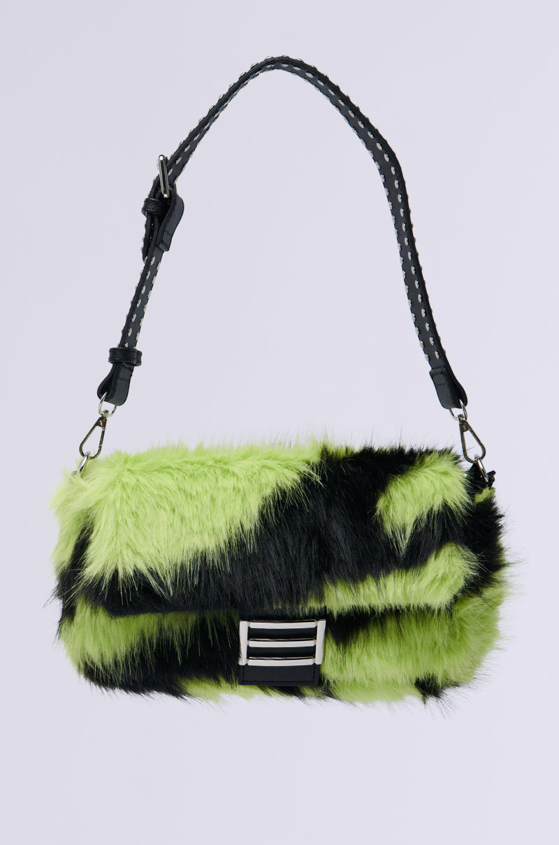 The WILD DREAMS ZEBRA FAUX FUR PURSE is a handbag featuring lime green and black zebra faux fur, a top strap, and silver buckle detail against a plain background.