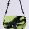 The WILD DREAMS ZEBRA FAUX FUR PURSE is a handbag featuring lime green and black zebra faux fur, a top strap, and silver buckle detail against a plain background.