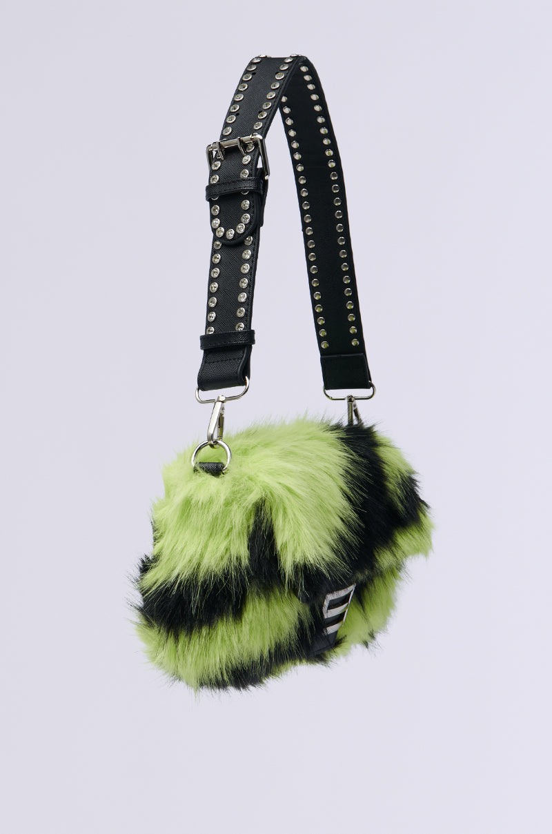 A WILD DREAMS ZEBRA FAUX FUR PURSE in lime green and black with a studded black leather strap and silver hardware is displayed against a plain white backdrop.