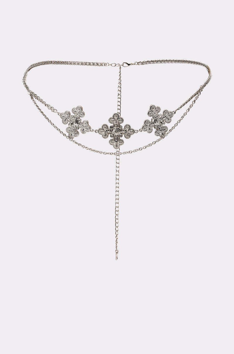 The SARAH CROSS CHAIN BELT is a silver, adjustable waist accessory with three ornate floral motifs and a central dangling chain, displayed on a plain white background. 1