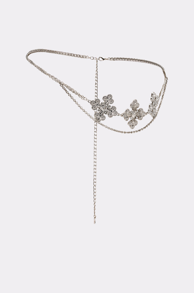 The SARAH CROSS CHAIN BELT is a silver waist accessory with ornate flower-shaped accents and dangling chains, shown elegantly against a plain white background. 2