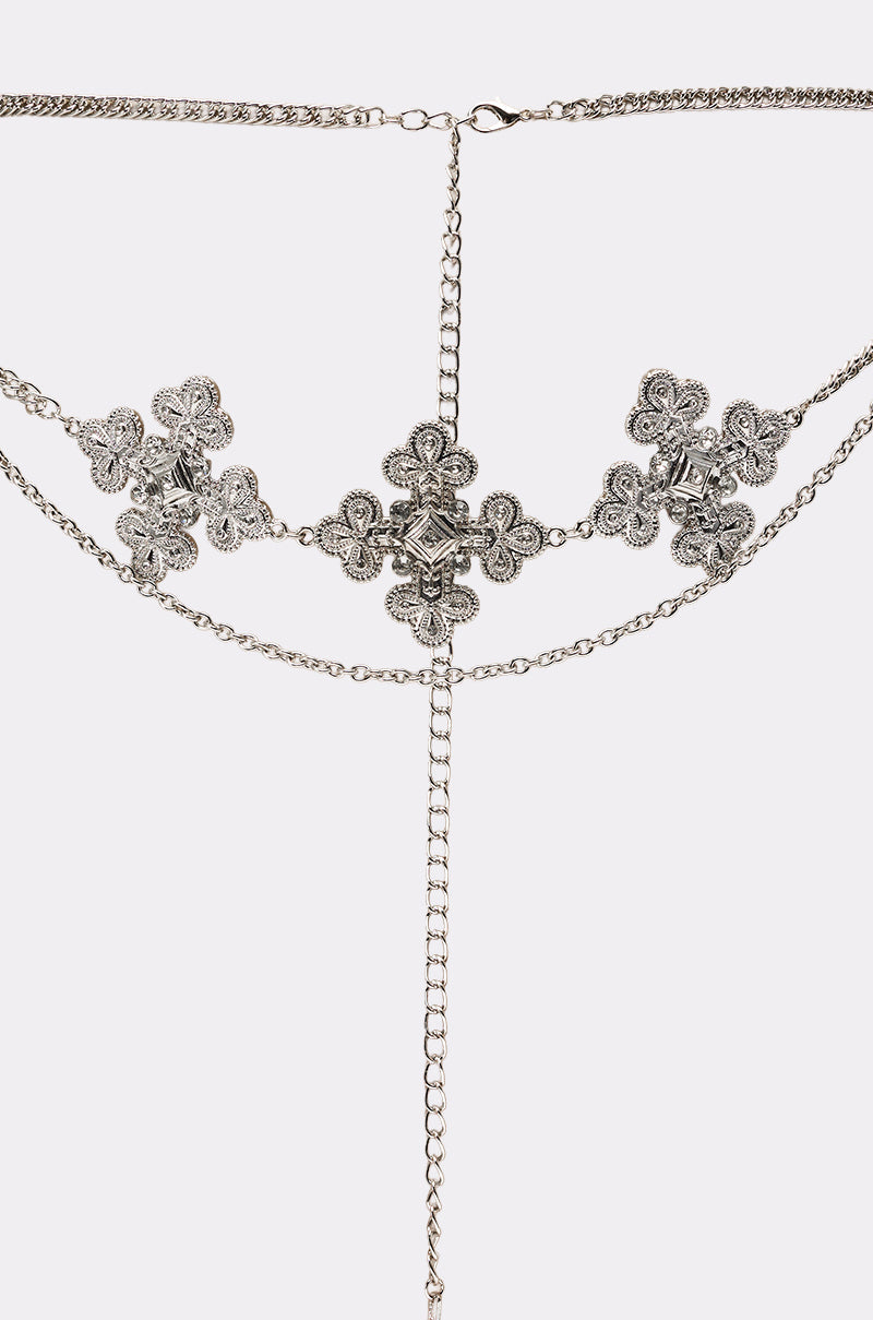The SARAH CROSS CHAIN BELT is a silver waist accessory with ornate medallions, intricate filigree floral designs, and interconnected chain links, displayed against a plain light background. 3